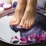 Female feet at spa pedicure procedure