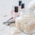 Selection of manicure tools on white wood background