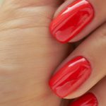 perfect red manicure. nail and hand care in the salon