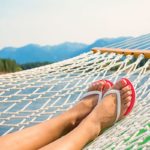 Woman relaxing in a hammock on a beautiful Mountain Lake