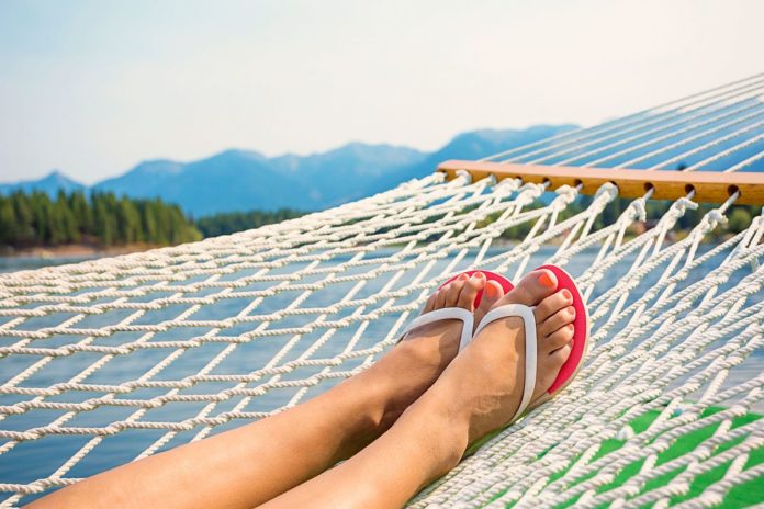 Woman relaxing in a hammock on a beautiful Mountain Lake